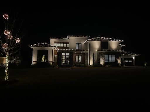 Modern luxury home with sophisticated white Christmas light display