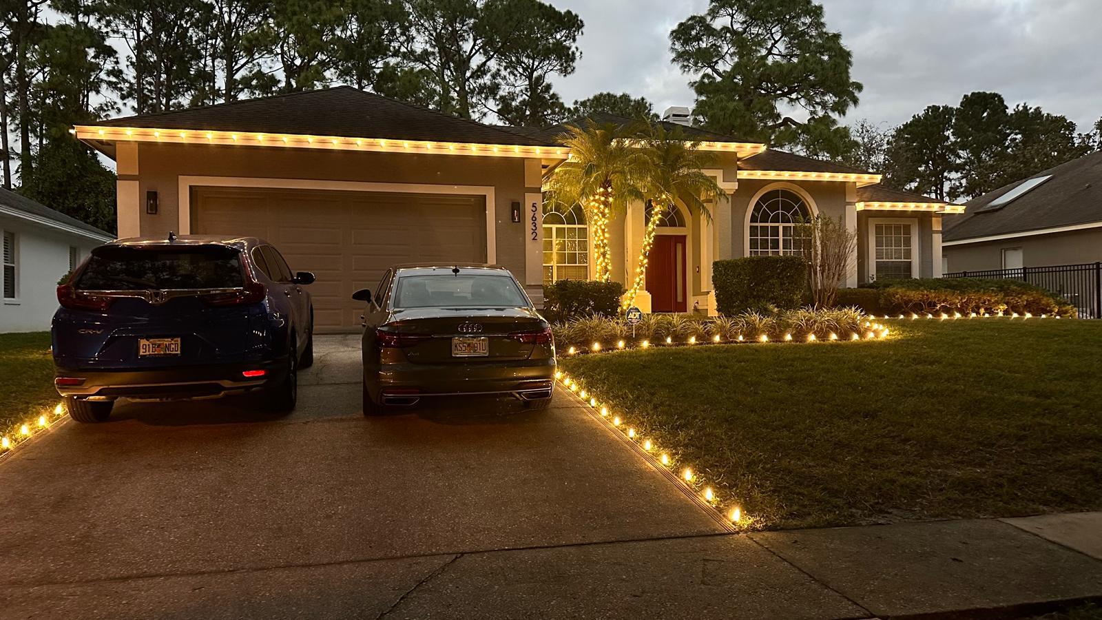 Beautiful home entrance with warm Christmas lights and illuminated columns